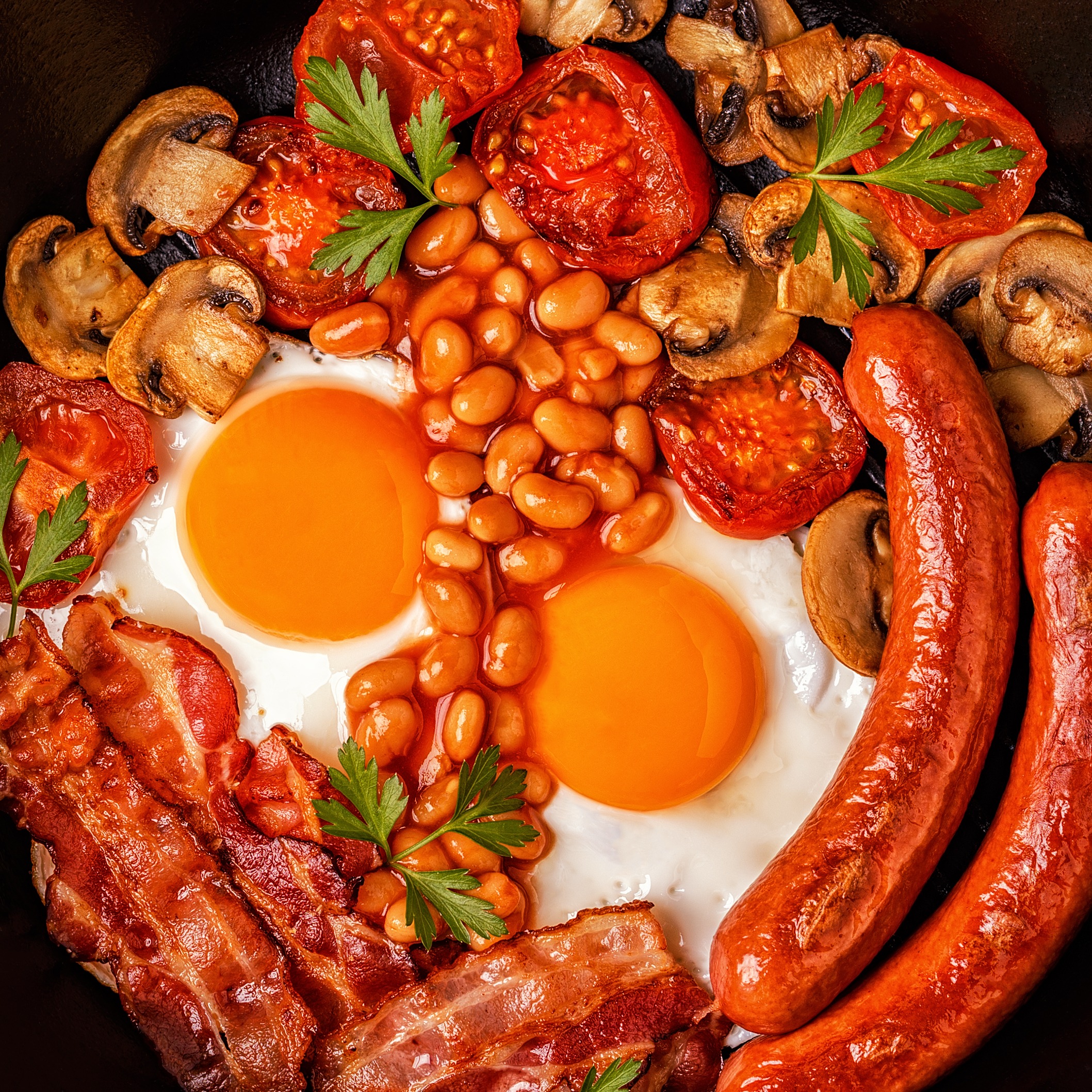 Traditional full English breakfast with fried eggs, sausages, be